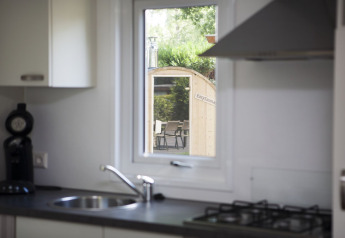 Kitchen view through window towards sauna at Veluwe lodge, Holiday park De Boshoek, Netherlands.