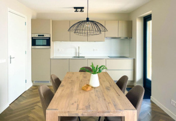 Moderne Küche und Essbereich in der Villa Oesterdam Comfort Extra im Oesterdam Resort, Niederlande.