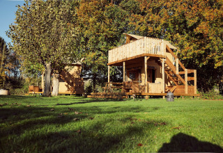 Tenda glamping Arriba al Resort de Parel nei Paesi Bassi, immersa nel verde e circondata da alberi.