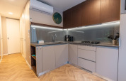 Modern kitchen inside Enzian lodge at Pressegger See, Austria, featuring sleek cabinets and appliances.