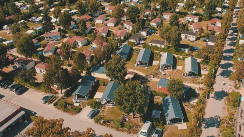 Luftaufnahme von Lodges und Ferienhäusern im Grünen im Vakantiepark Leukermeer in den Niederlanden.