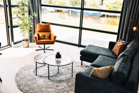 Sala moderna en Villa Nautica Deluxe, MarinaPark Residentie Nieuw Loosdrecht, Países Bajos, vista junto al agua.