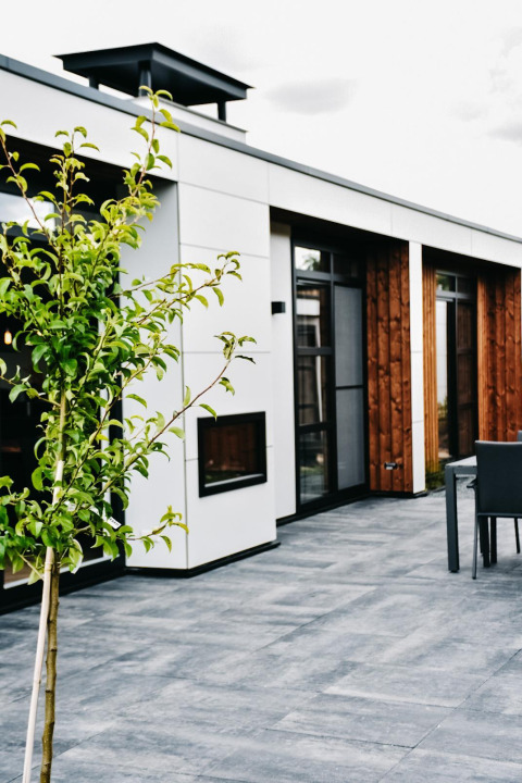 Terraza moderna de la Villa Nautica Deluxe en MarinaPark Residentie Nieuw Loosdrecht, Países Bajos, con vegetación.