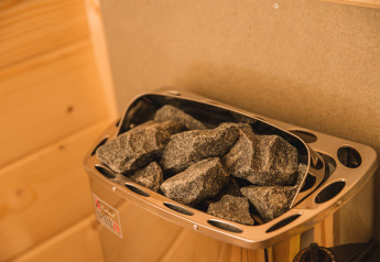 Sauna heater with hot sauna stones at the Luxury lodge + sauna in Vakantiepark Hölte, Netherlands.