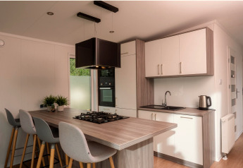 Petite cuisine moderne dans une Tiny Cabin au Vakantiepark Hölte, Pays-Bas, avec îlot et plaque au gaz.