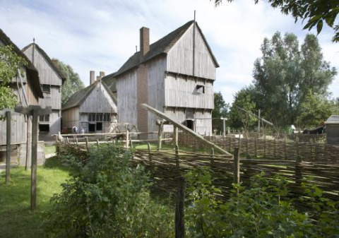 Edificios de madera y vallas tejidas en Expedition Archeon, un parque vacacional en Holanda Meridional, Países Bajos.
