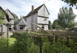 Edificios de madera y vallas tejidas en Expedition Archeon, un parque vacacional en Holanda Meridional, Países Bajos.