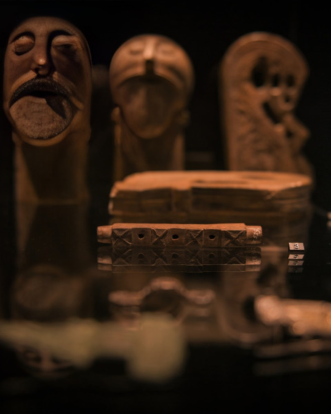 Close-up view of ancient masks and artifacts on display at Expedition Archeon, South Holland, Netherlands.
