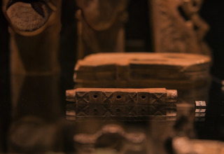 Close-up view of ancient masks and artifacts on display at Expedition Archeon, South Holland, Netherlands.