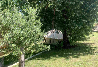 Zelt unter Bäumen im Glamping de Cerveira, Ferienpark im Norden Portugals, umgeben von viel Grün.