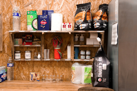 Well-stocked pantry with food and essentials at Feather Down Les Jardins des Coccinelles in Brittany, France.