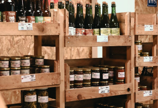 Shelves with local products and bottles at Feather Down Les Jardins des Coccinelles, Brittany, France.