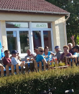 Groep vakantiegangers geniet van drankjes buiten bij Camping Seasonova Les Marguerites, Hauts-de-France.