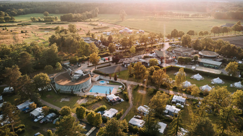 Aerial view of Recreatiepark De Achterste Hoef, a holiday park surrounded by greenery in North-Brabant, Netherlands.