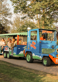 The colorful Zoef Express train transports families around the scenic holiday park De Achterste Hoef.