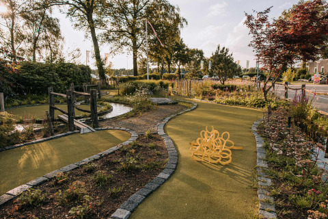 Mini-golf course amid lush greenery at Recreatiepark De Achterste Hoef, North-Brabant, Netherlands.