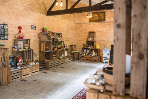 Rustic shop at Feather Down Botterheerd holiday park in Groningen, Netherlands, featuring local goods.