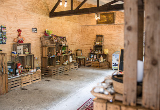 Rustic shop at Feather Down Botterheerd holiday park in Groningen, Netherlands, featuring local goods.