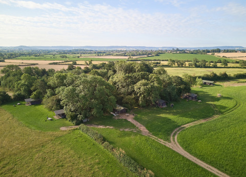 Vista aérea del parque vacacional Feather Down Moor Farm en el suroeste de Inglaterra, rodeado de campos.