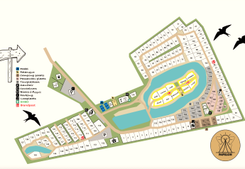 Kort over campingplads med forskellige faciliteter som parkering, søer, boldbaner og hytter markeret.