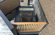 Udendørs område ved Tiny Loft i Veluwepark de Bosgraaf, Holland, med moderne arkitektur og terrasse.