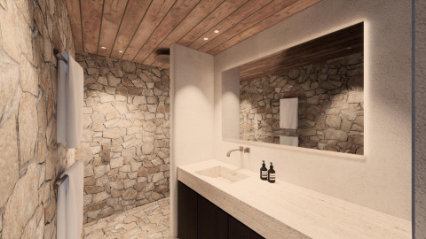 Luxe lodgebadkamer met natuurstenen muren, houten plafond, groot spiegel en modern wastafelmeubel.