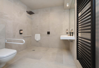 Handicapvenligt badeværelse på Villa Lodge med Jacuzzi hos Woodz Lodges i Belgien, moderne design.