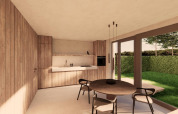 Moderne køkken- og spisestue med træpaneler og store vinduer, der vender ud mod en grøn have ved Group Lodge.