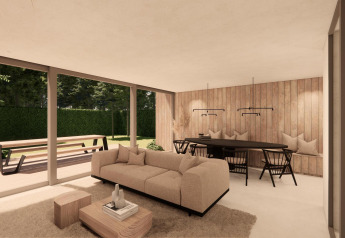 Soggiorno moderno della Group Lodge presso Woodz Lodges in Belgio, con grandi vetrate e vista giardino.