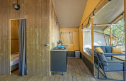 Indretning af en luksuriøs safaritelte med aircondition og udendørs siddeplads på Camping Lanterna i Kroatien.