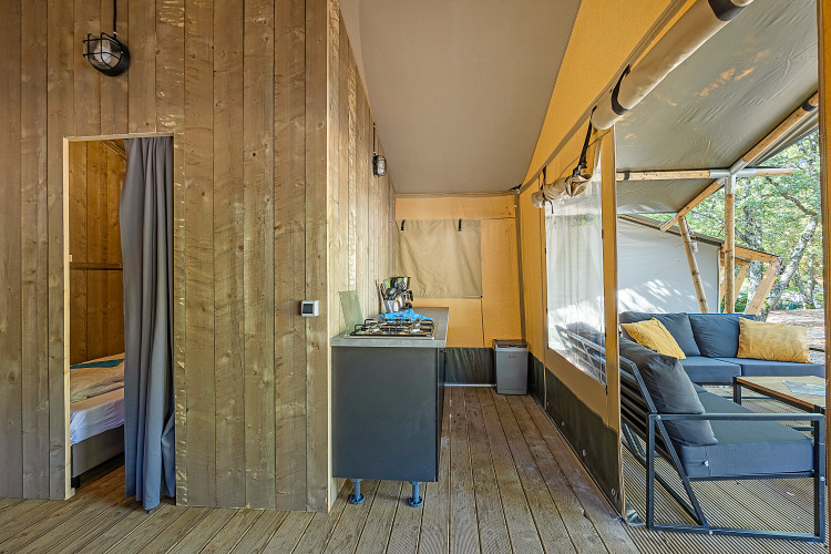 Interior view of a Safari tent Lodge with air conditioning and lounge area at Camping Lanterna, Croatia.