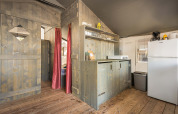 Interior view of Safari Tent Luxury at Camping Lanterna in Croatia featuring kitchenette and wood walls.
