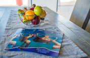Fruit bowl and brochures on dining table inside Safari Tent Luxury at Camping Lanterna, Croatia.