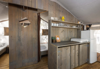 Entrance to bedroom and kitchen area inside a luxury safari tent at Camping Lanterna in Croatia.