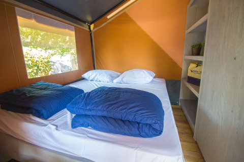 Interieur van Safari tent Comfort met airconditioning en tweepersoonsbed op Camping Porto Sole, Kroatië.
