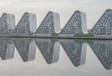 Bâtiments modernes en forme de vague près de Stouby, au Danemark, reflétés magnifiquement sur l’eau.