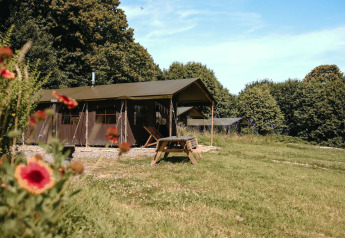 Tenda safari al Feather Down Ô manoir de Glams in Francia con doccia privata e fiori in primo piano