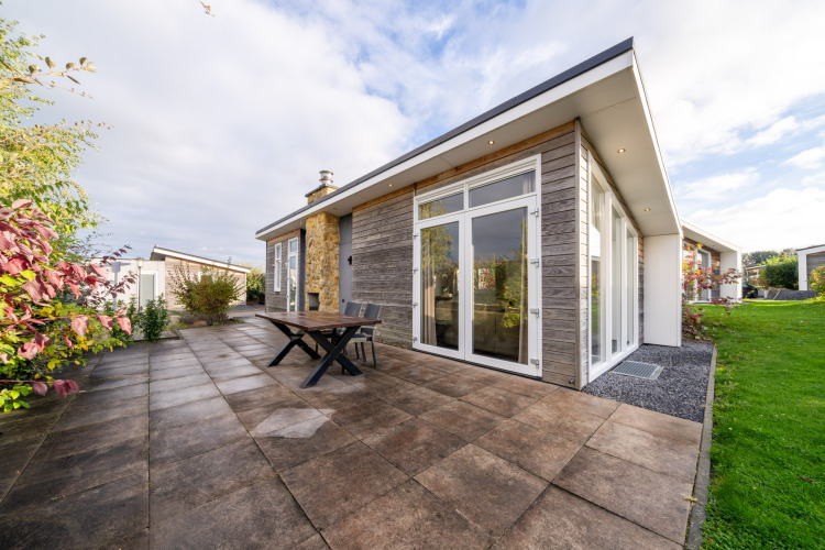 Modern lodge with patio and large glass doors at Resort Mooi Bemelen, Netherlands, Biebosch - Sunshower.