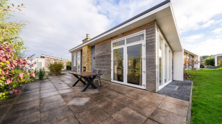 Modern lodge with patio and large glass doors at Resort Mooi Bemelen, Netherlands, Biebosch - Sunshower.