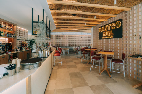 Interior of Gastro Suel Restaurant at Camping Costa del Sol with bar, wood accents and relaxed Andalusian style.