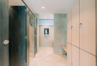 Modern changing room with lockers and benches at Camping Costa del Sol Glamping Village in Andalusia, Spain.