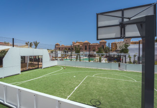 Multi-sports court with basketball hoop and soccer goal at Camping Costa del Sol Glamping Village, Andalusia.