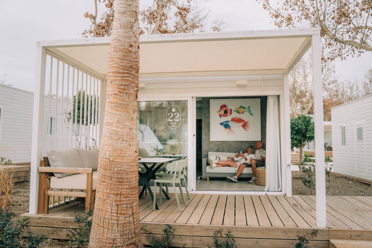 Pet-friendly Bungalow Neri at Camping Costa del Sol Glamping Village, Spain, with two people relaxing inside.
