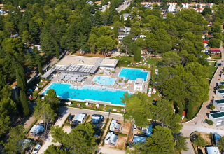 Luftfoto af Camping Valkanela, en feriepark i Istrien, Kroatien, med swimmingpools og træomgivelser.
