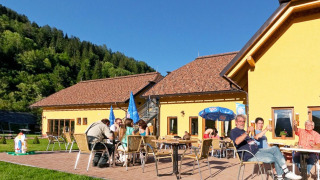 Guests enjoying outdoor dining and sunshine at Camping Bella Austria holiday park in Styria, Austria.