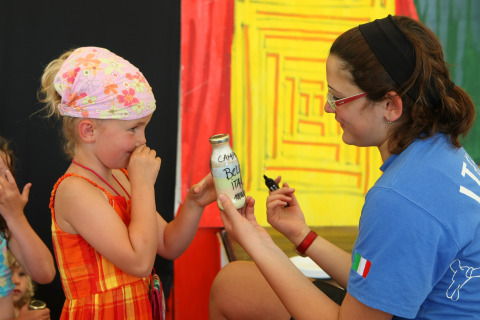 Una donna mostra una bottiglia a una bambina a Camping Bella Italia, un villaggio vacanze in Veneto.