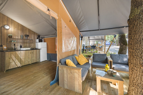 Safari tent with sanitary facilities at Camping Aminess Maravea, Croatia, featuring a cozy lounge area.