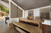 Interior view of a Safari Tent Luxury at Camping Polari in Croatia with a wooden table and benches.