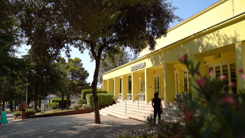 Reception area of Camping Porto Sole holiday park in Istria, Croatia, surrounded by trees and greenery.