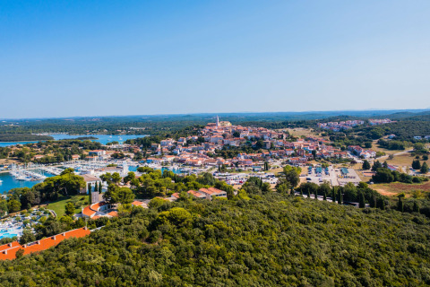 Vista aérea del camping Porto Sole en Istria, Croacia, rodeado de bosque, puerto deportivo y ciudad.